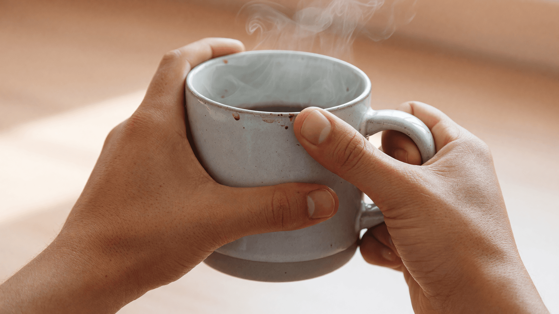 Hands Holding a Coffee Cup