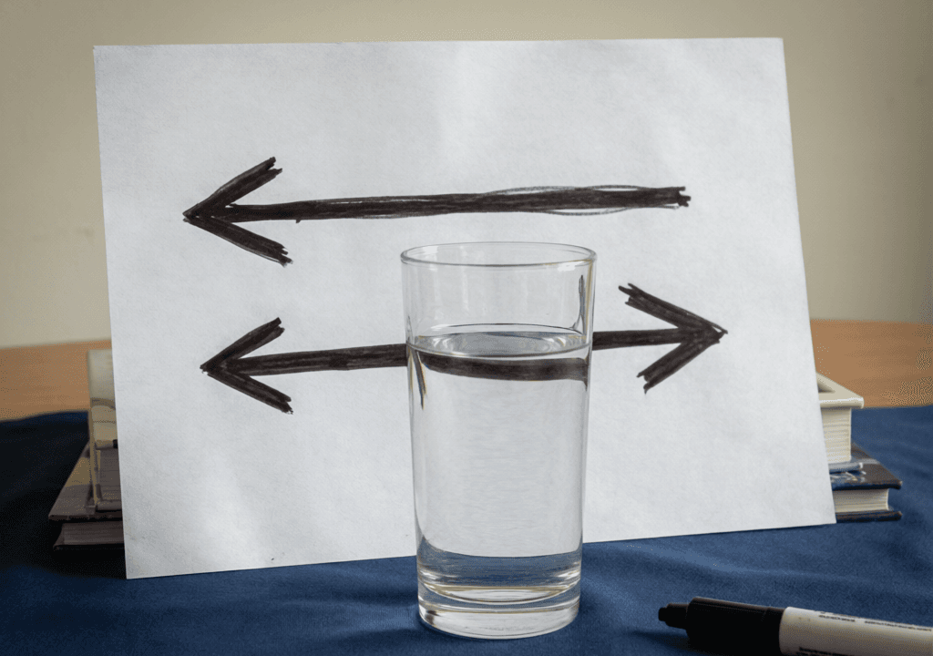 Two Arrows Behind a Glass of Water